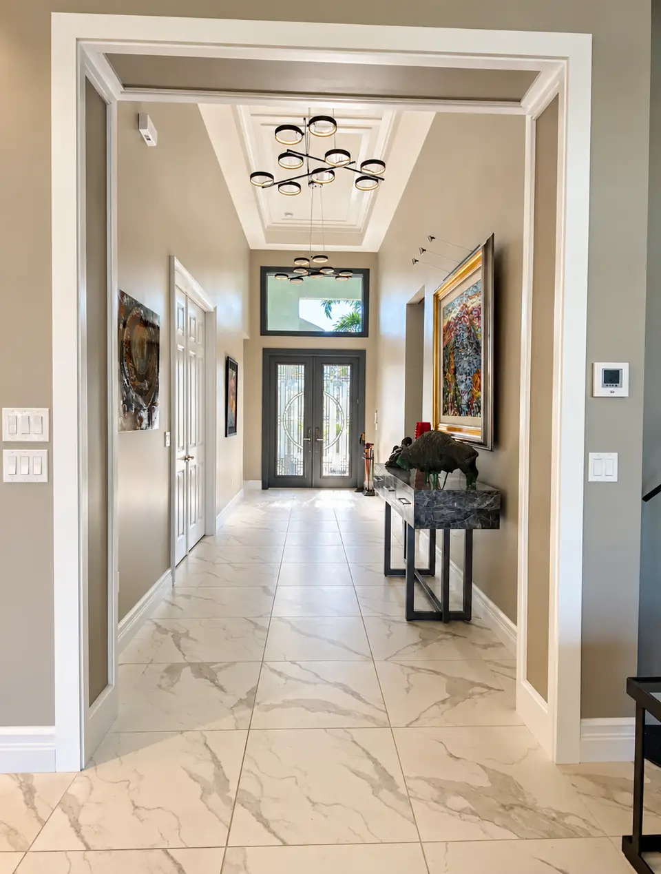 Series of cased openings down a marble-floored hallway