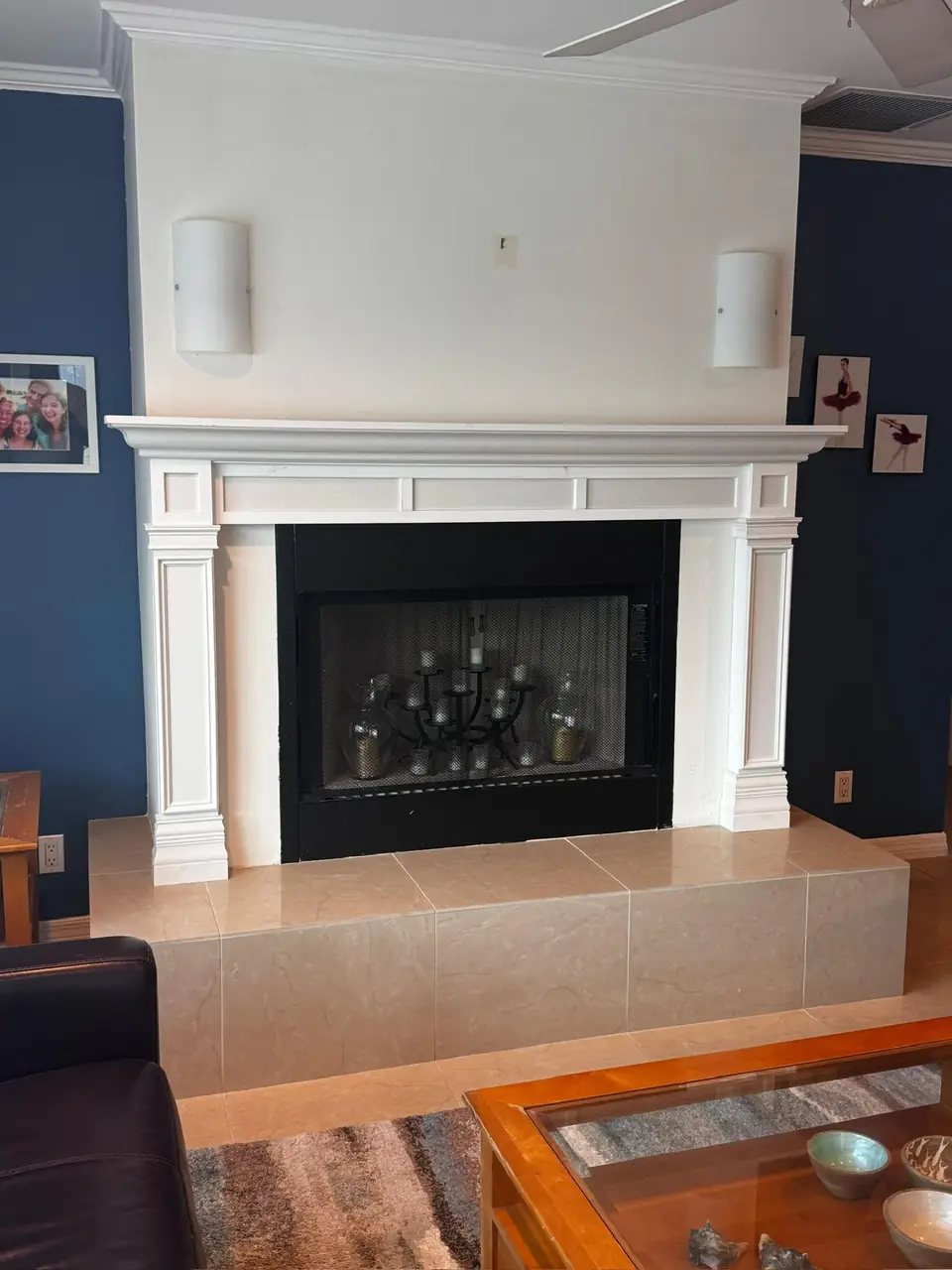 White fireplace mantel against a navy wall