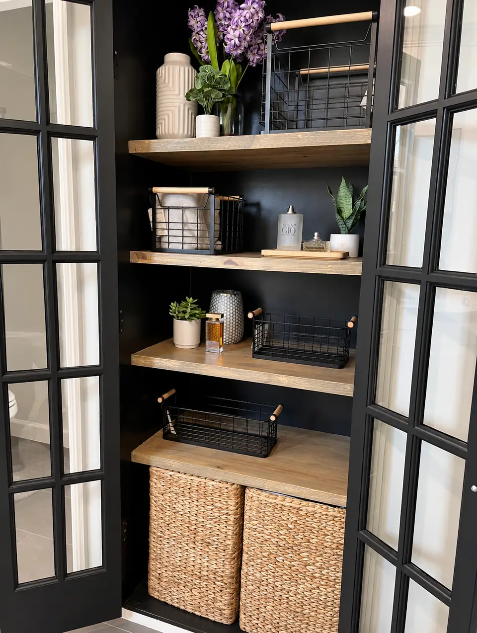 Black glass-front cabinet with wood shelves