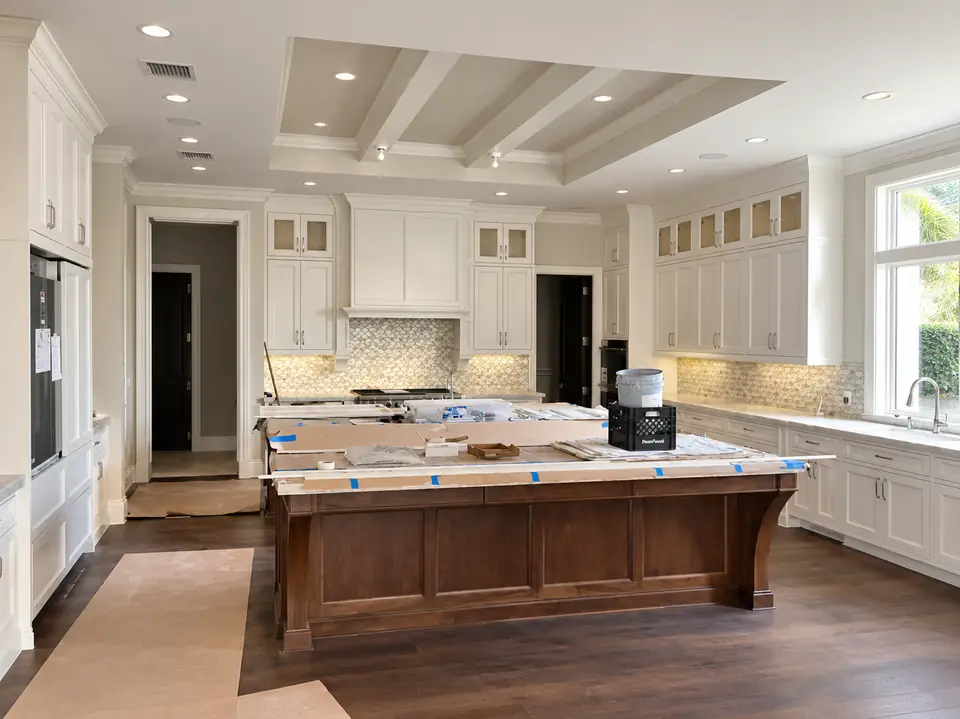 Kitchen island and cabinetry under a coffered ceiling