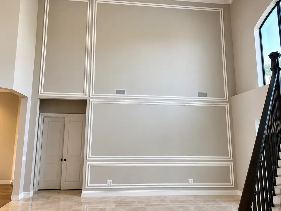 Applied molding panels on a two-story wall